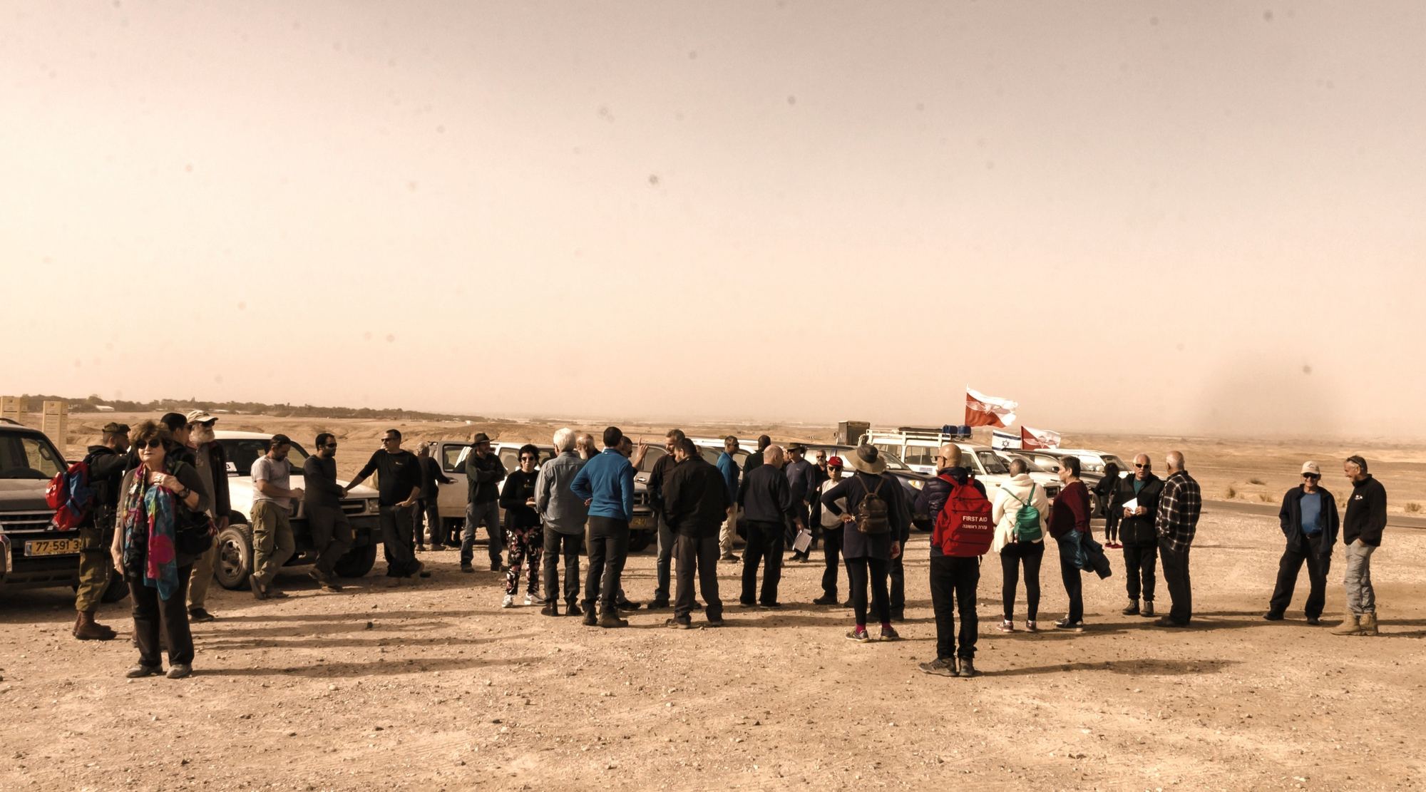 Families and volunteers of the foundation gathered beside jeeps in the Negev desert, the paratroopers' flag flying.